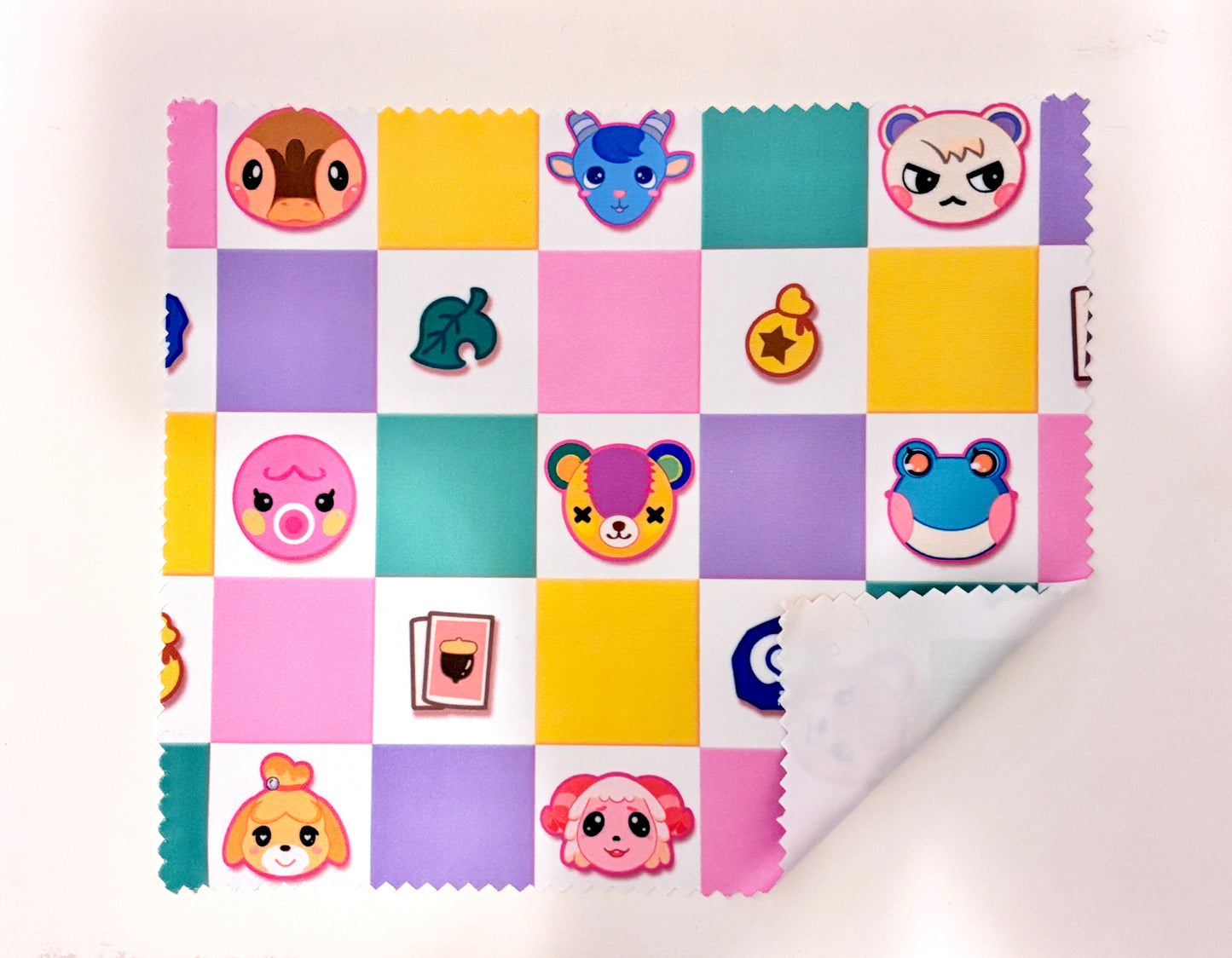 Colorful patchwork pattern with cartoon character faces on a white background