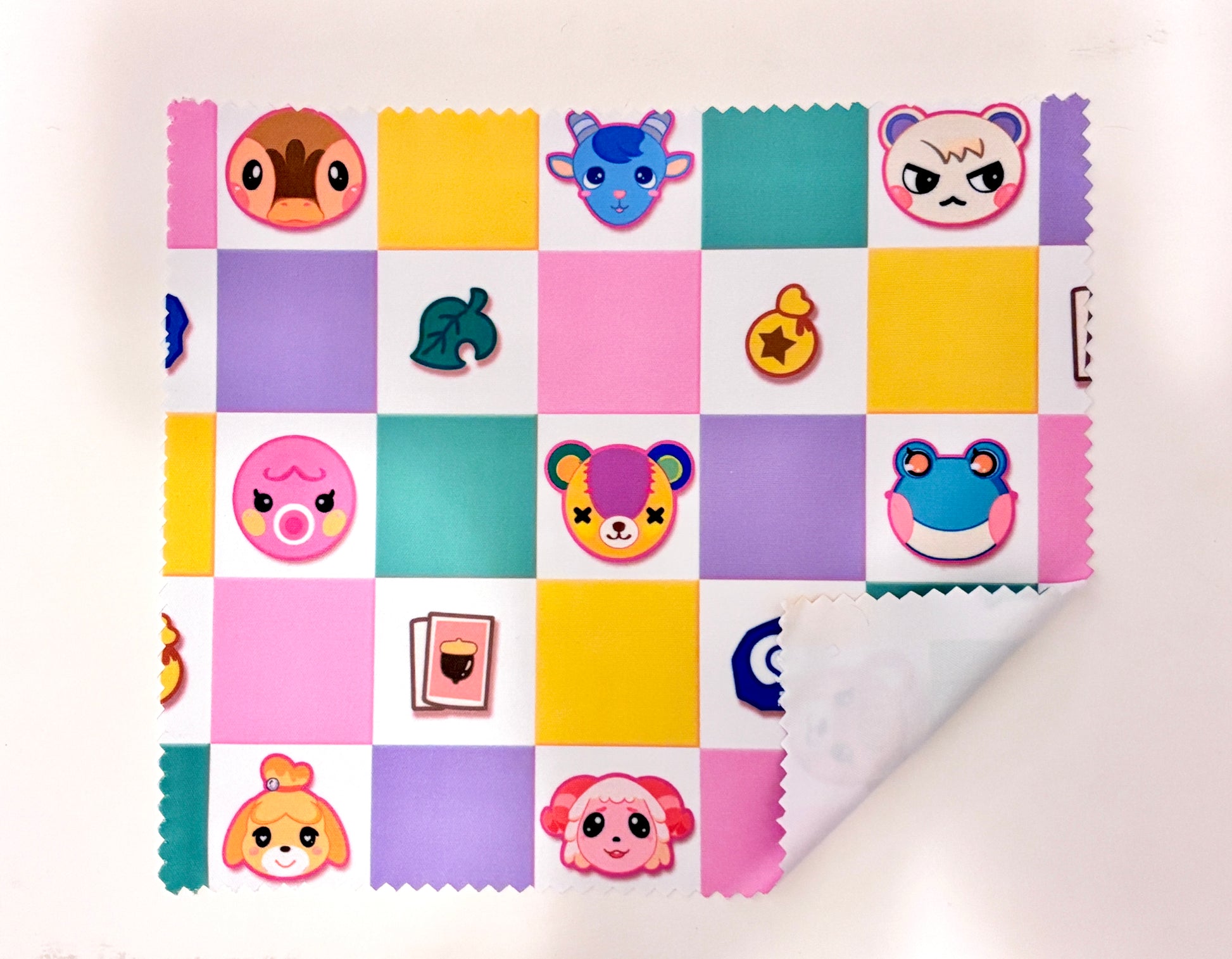 Colorful patchwork pattern with cartoon character faces on a white background