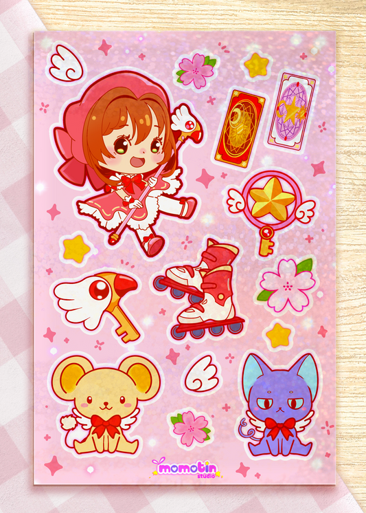 A pink sticker sheet featuring cute anime-style characters and accessories, including a girl with brown hair, a mouse, a blue cat, roller skates, a wand, and stars and flowers on a sparkly pink background. The brand name 'momotin' is printed at the bottom.