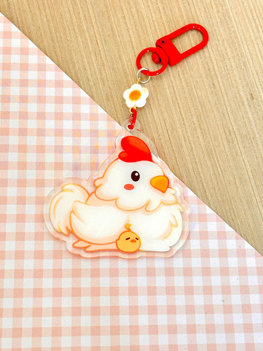 Keychain with cartoon chicken design on a checkered fabric background