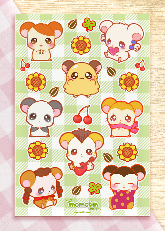 A sheet of cute cartoon hamster stickers on a light green plaid background, featuring multiple hamster illustrations in different poses with flowers, cherries, and leaves. The brand name 'momotin' is printed at the bottom.